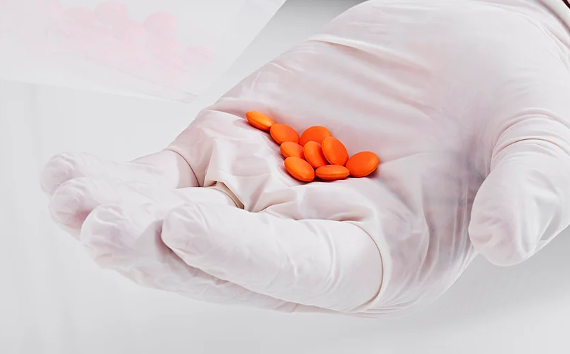 Orange tablets coated with the Mini Coater Drier